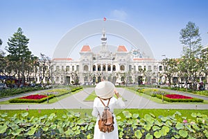 Tourist woman is sightseeing at famous landmark of Hochiminh City `People`s of Committee of Hochiminh City`