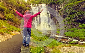 Tourist woman by Skjervsfossen Waterfall - Norway