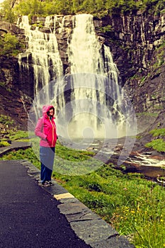 Tourist woman by Skjervsfossen Waterfall - Norway