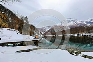 Tourist woman in the snow mountain with rivers at the Kamikochi in Japan Alps Mountain. Winter season concept