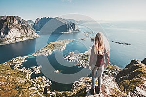 Tourist woman standing on cliff of Reinebringen mountain aerial view