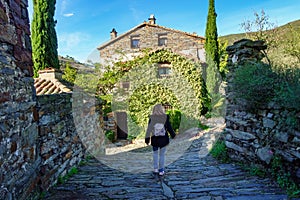 Tourist woman strolling through the streets of the picturesque stone village, Patones de Arriba. photo