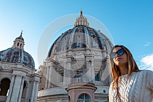 Rome - Tourist woman with close up view on the main dome of Saint Peter basilica in Vatican city, Rome, Europe