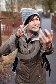 Tourist woman taking selfie with mobile phone