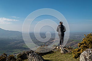 Tourist woman on top of the mountain enjoying the beautiful landscape