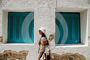 The tourist woman travels on the streets of Greek cities