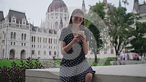 Tourist woman is using mobile phone in Budapest, Hungary