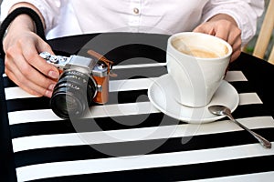 Tourist woman digital camera street cafe terrace girl hat sun vintage travel photo shooting white cup coffee panasonic lumix