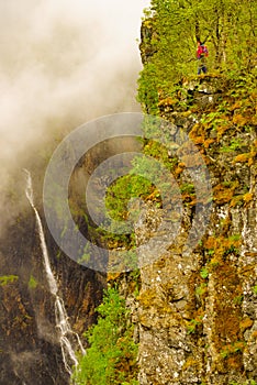 Tourist woman by Voringsfossen waterfall, Norway