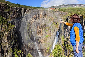 Tourist woman by Voringsfossen waterfall, Norway