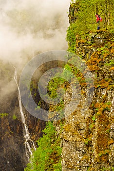 Tourist woman by Voringsfossen waterfall, Norway