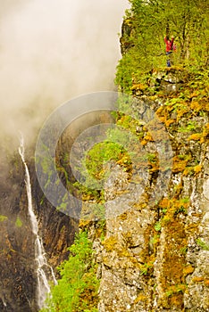 Tourist woman by Voringsfossen waterfall, Norway