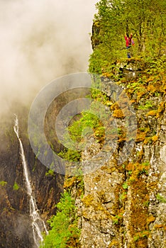 Tourist woman by Voringsfossen waterfall, Norway