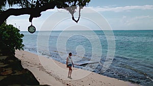 Tourist woman walking ocean coastline slow motion