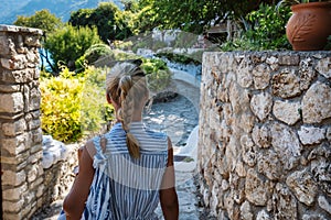 A tourist woman on the walking path in Agios Nikitas village on Lefkas Ionian Island, Greece