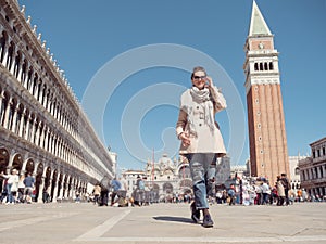 Tourist woman walking on the Piazza San Marco. photo