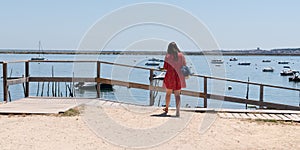 Tourist young woman on Cap Ferret Herbe port at Arcachon berry in France look atlantic beach in web banner template