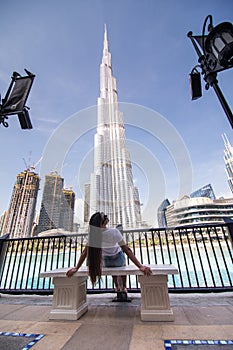 Tourist young woman enjoying the view of the Burj Khalifa skyscraper and the fountain