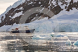 Touristic antarctic cruise liner drifting in the lagoon among th