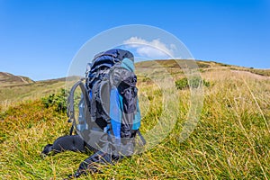 Touristic backpack among a green mountains