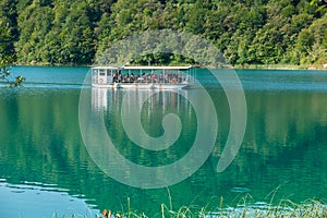 Touristic boat on beautiful azure Plitvice lake