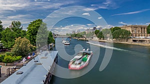 Touristic boat passes below Pont des Arts and stop on boat station on Seine river timelapse hyperlapse in Paris.