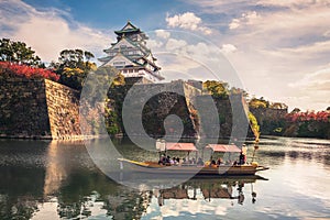 Touristic boats with tourists along the moat of Osaka Castle, Osaka, Japan
