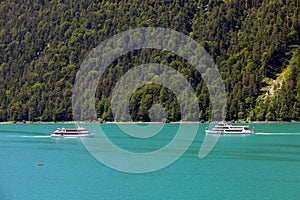 Touristic boats on the turquoise waters of Achensee, Tirol, Austria