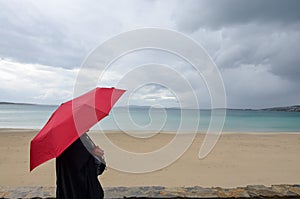 Touristic destination beach female with red umbrella turquise sea