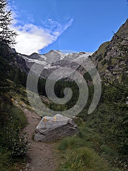 Touristic path in the mountains marked with yellow signs.
