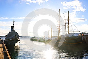 Touristic scenic view of the Oslo harbour near the Akershus Fortressand the city in the dusk , Norway, Europe