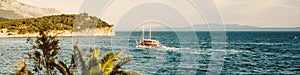 Touristic ship on waves of Adriatic sea under blue sky in Croatia, croatian riviera popular location