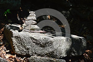 Touristic stone cairn on larger sunlit rock. Location Mala Fatra mountains, northern Slovakia.