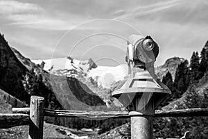 Touristic telescope in alpine valley