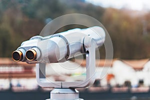 Touristic telescope look at the city with view snow mountains, closeup metal binocular on background viewpoint observe vision