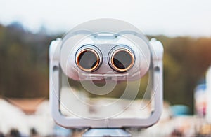 Touristic telescope look at the city with view snow mountains, closeup metal binocular on background viewpoint observe vision