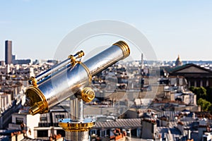 Touristic telescope overlooking Paris from the roof of Printemps Department Store