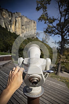 Touristic telescope pointing the vertical walls of the stone of Bismantova