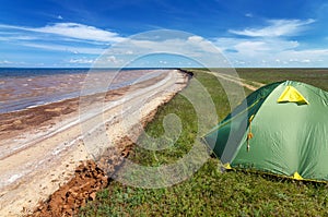 Touristic tent in astrakhan steppe under beautiful sky. Panorama of nature near salt lake Baskunchak