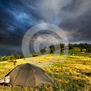 Touristic tent and storm clouds