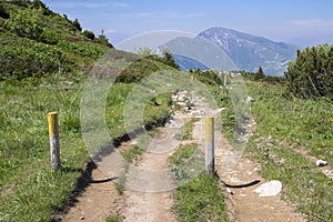 Touristic trail Alta Via del Monte Baldo, ridge way in Garda Mountains, wooden sticks defining the way