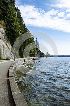 Touristis on stanley park seawall on a sunny summer day