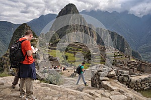 Tourists admiring the breathtaking views of the iconic Maccu Michu in South America photo