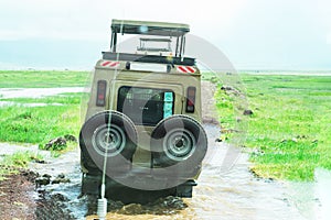 Tourists in all-terrain vehicle exploring the elephants in safari game drive