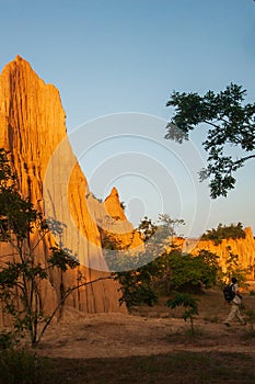 Tourists at ancient scenic landscape at sunset. The Sao Din Na Noi site displays picturesque scenery of eroded sandstone pillars,