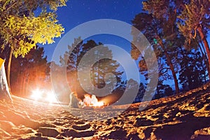 Tourists around the campfire at night. Olkhon Island Lake Baikal