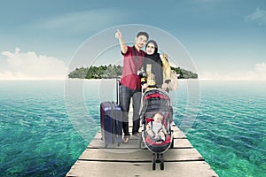 Tourists with a baby carriage on the pier