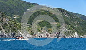 Tourists on a boat arriving to Vernazza, one of the five towns t