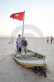 Tourists on a boat at salt lake Chott El Jerid