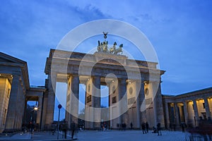 Tourists at the Brandenburg Gate in Berlin in the evening